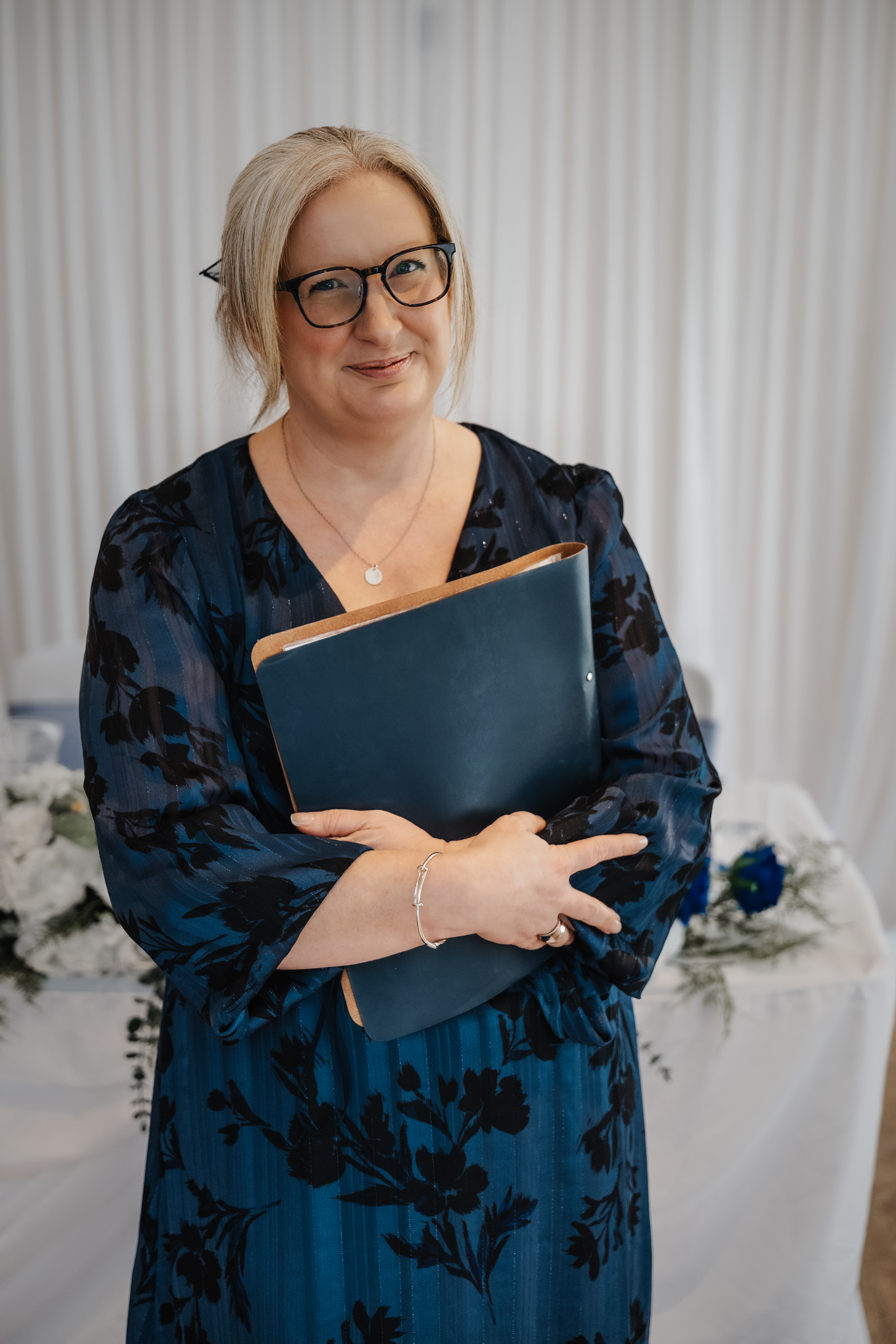Deb Reed Celebrant based in Colchester Essex sitting smiling before a wedding.